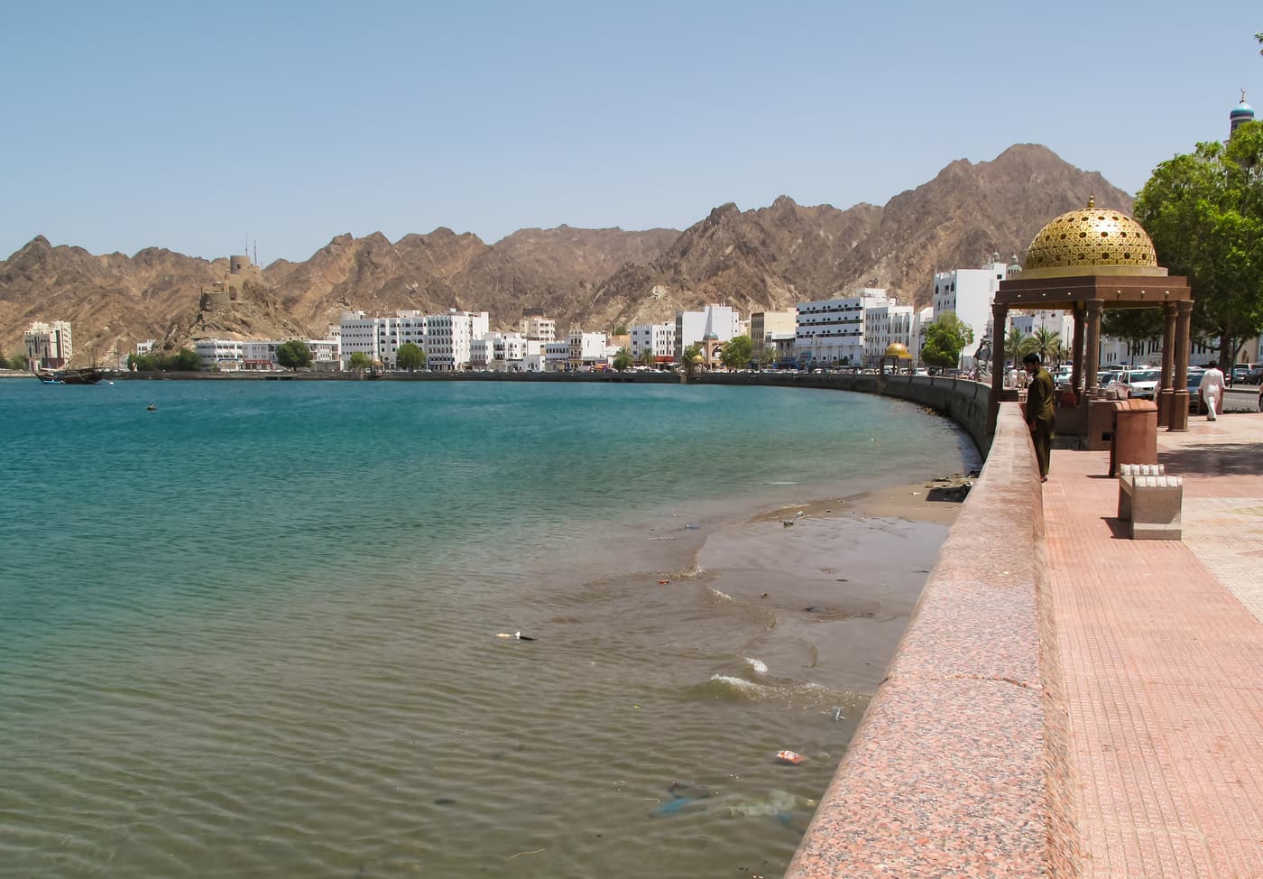 Mutrah Corniche curving along the harbour below the mountains