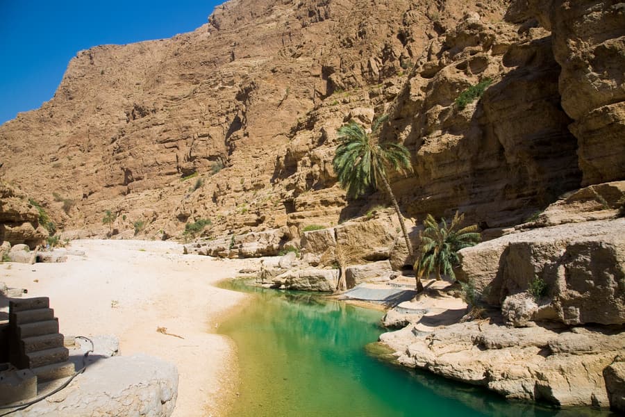 Turquoise pools between the canyon walls of Wadi Shab
